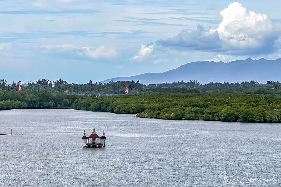 Meeresküste mit kleinem Tempel im Wasser vor Lombok